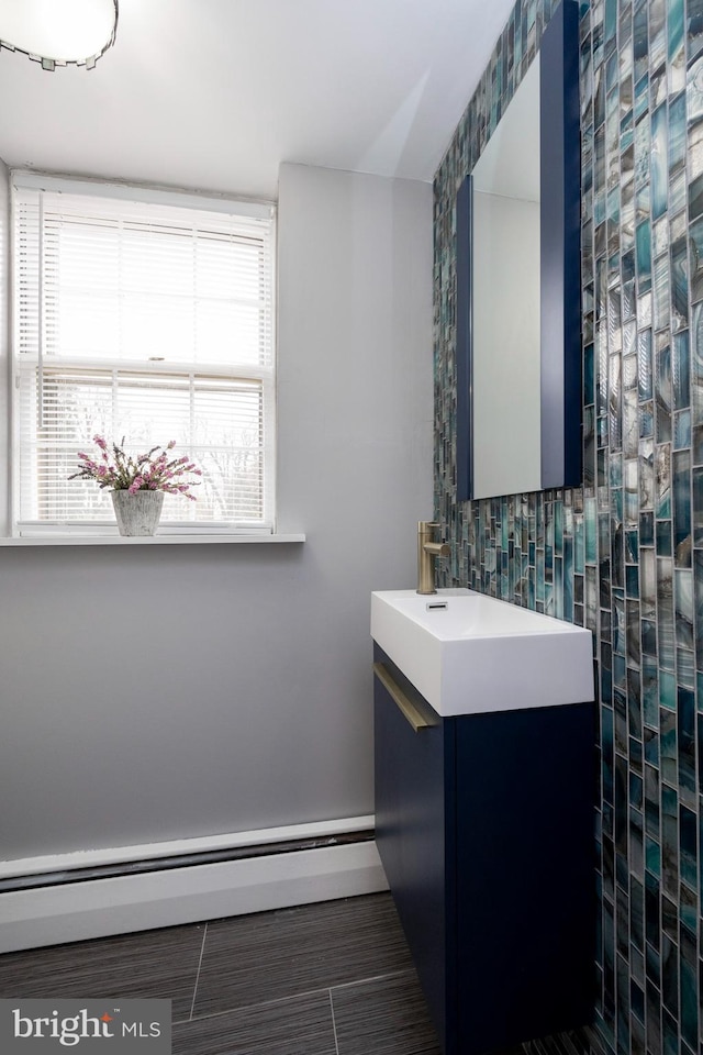 bathroom featuring vanity, tile patterned flooring, and a baseboard heating unit