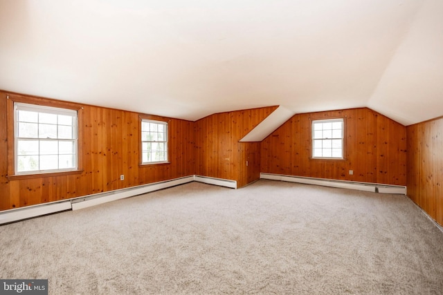 bonus room featuring a baseboard radiator, lofted ceiling, and plenty of natural light