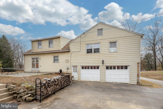 back of property featuring a garage