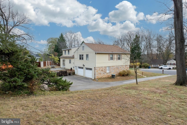 view of property exterior featuring a garage and a lawn