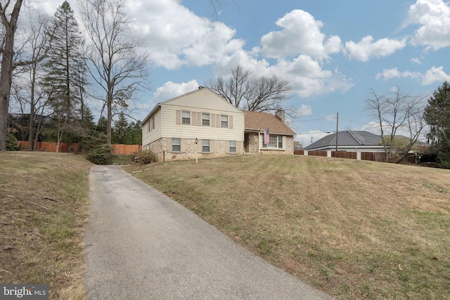 tri-level home with a front lawn