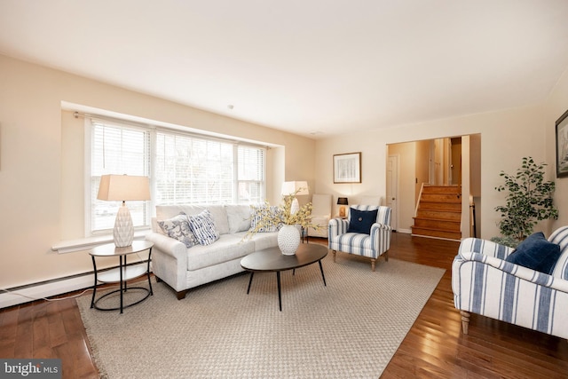 living room featuring dark wood-type flooring and baseboard heating