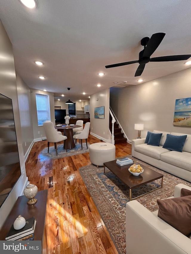 living room with hardwood / wood-style floors and ceiling fan