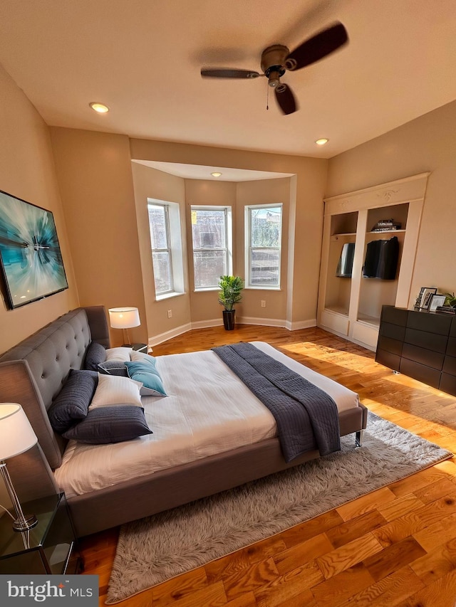 bedroom with ceiling fan and light wood-type flooring