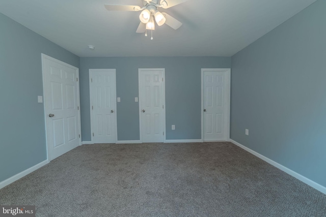 unfurnished bedroom featuring two closets, ceiling fan, and carpet floors