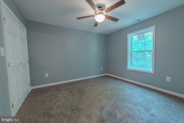 empty room with carpet floors and ceiling fan