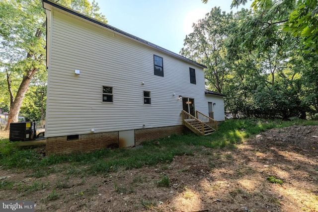 rear view of property featuring central AC