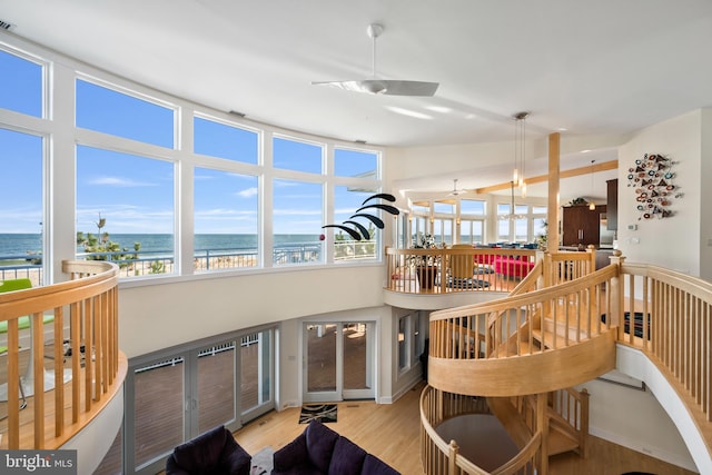 sunroom / solarium featuring a water view and a view of the beach