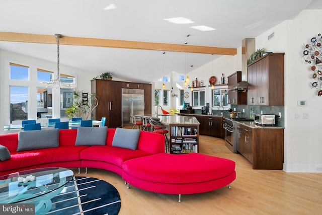101-E Long Beach Blvd, Long Beach Township, NJ 08008 - living area featuring light wood-style floors, a chandelier, baseboards, and lofted ceiling