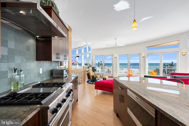 101-E Long Beach Blvd, Long Beach Township, NJ 08008 - kitchen with appliances with stainless steel finishes, wall chimney range hood, plenty of natural light, and backsplash