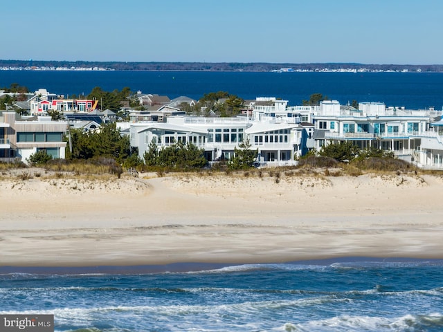 bird's eye view with a water view and a view of the beach