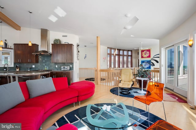 living room featuring light wood-type flooring and sink