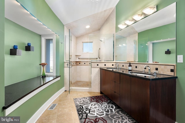 101-E Long Beach Blvd, Long Beach Township, NJ 08008 - bathroom featuring a shower stall, tile patterned flooring, vaulted ceiling, double vanity, and baseboards