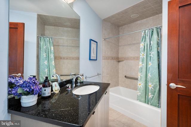 bathroom with tile patterned flooring, shower / bath combo, and vanity