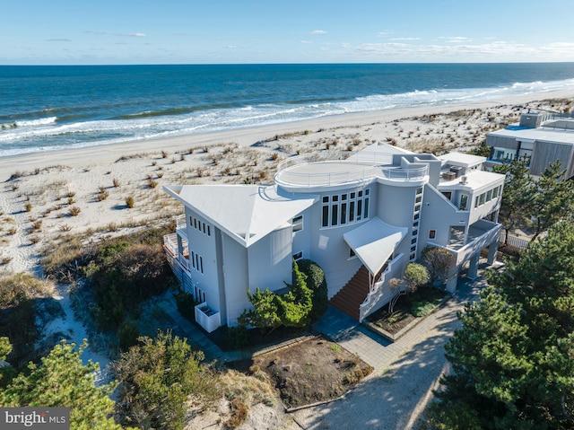 birds eye view of property with a view of the beach and a water view