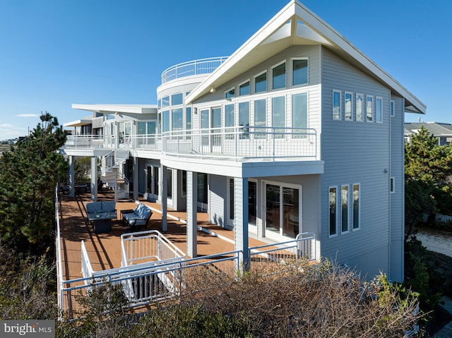 rear view of house featuring outdoor lounge area and a balcony