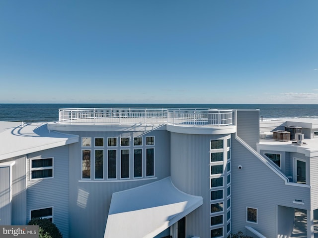 exterior space featuring a beach view and a water view