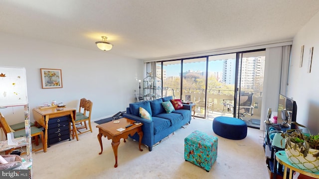 living room with carpet flooring, expansive windows, and a textured ceiling