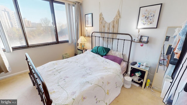 bedroom featuring light colored carpet