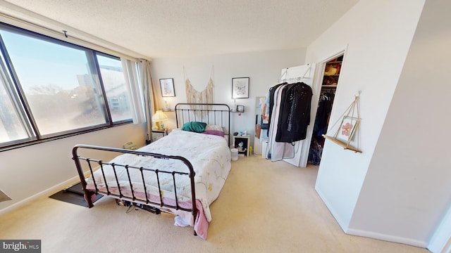 bedroom featuring light carpet and a textured ceiling