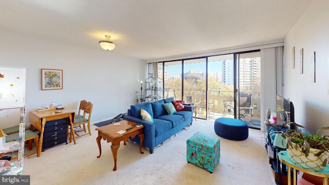 living room with a textured ceiling, a wall of windows, and carpet floors