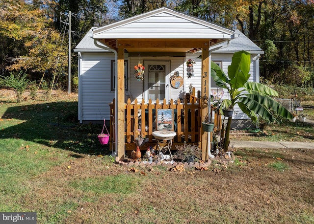 view of outdoor structure featuring a lawn