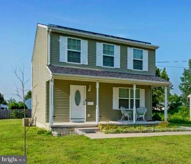 view of front of home with a porch and a front lawn