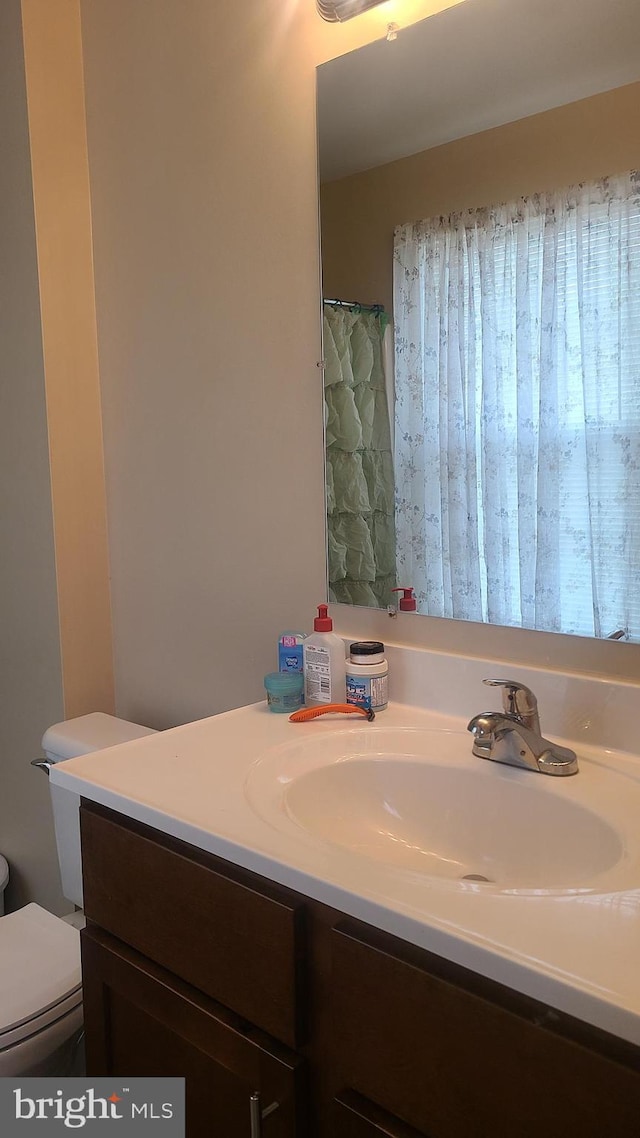 bathroom featuring vanity and toilet