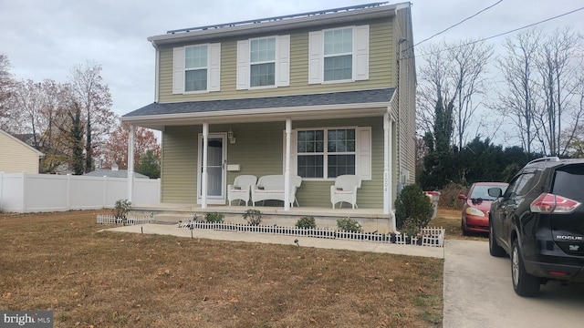 view of front of house featuring covered porch and a front yard