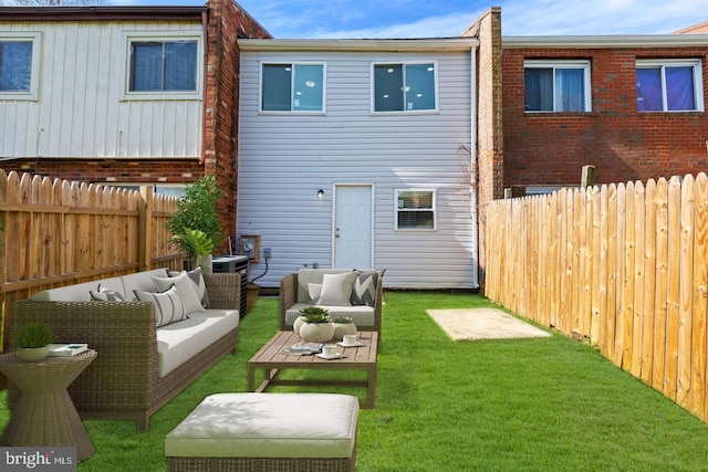 back of property with an outdoor hangout area and a lawn