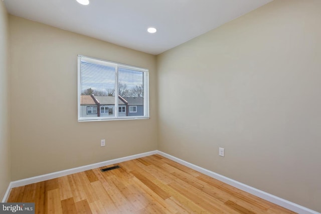 spare room with wood-type flooring