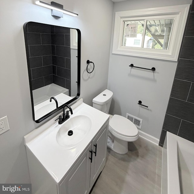 full bathroom with toilet, shower with separate bathtub, and vanity