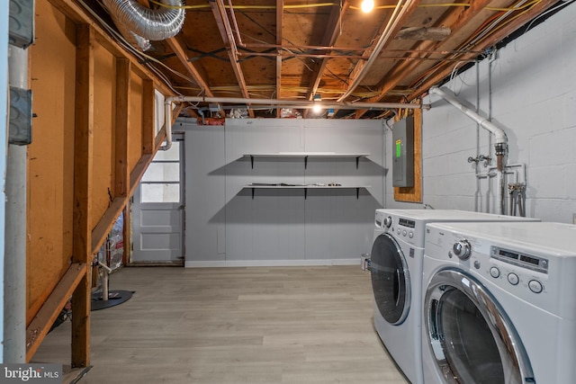 washroom featuring light hardwood / wood-style floors, electric panel, and independent washer and dryer