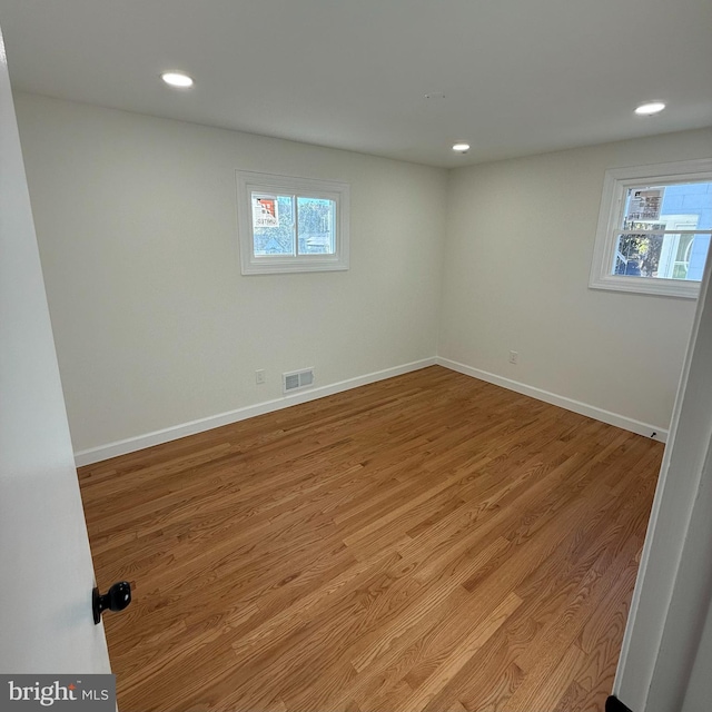 basement featuring light wood-type flooring and a wealth of natural light