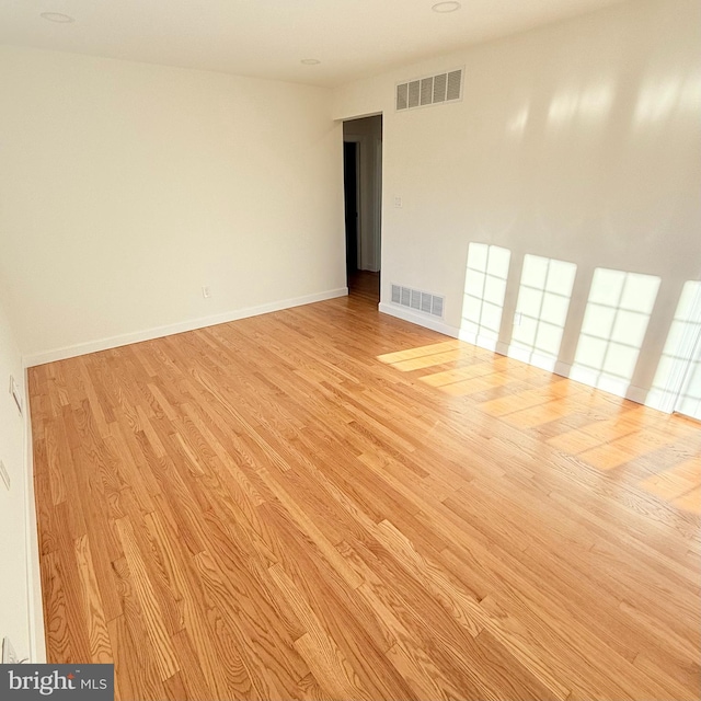 unfurnished room with light hardwood / wood-style floors