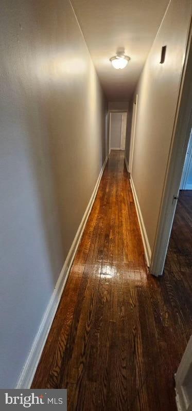 corridor featuring dark hardwood / wood-style floors