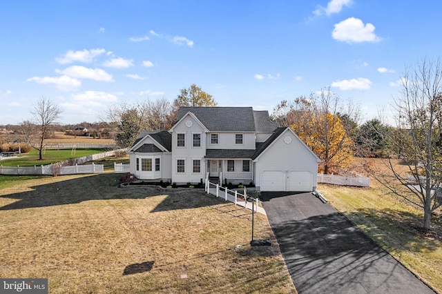 view of front of property featuring a garage and a front lawn