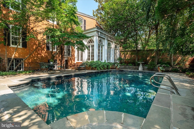 view of swimming pool with a patio