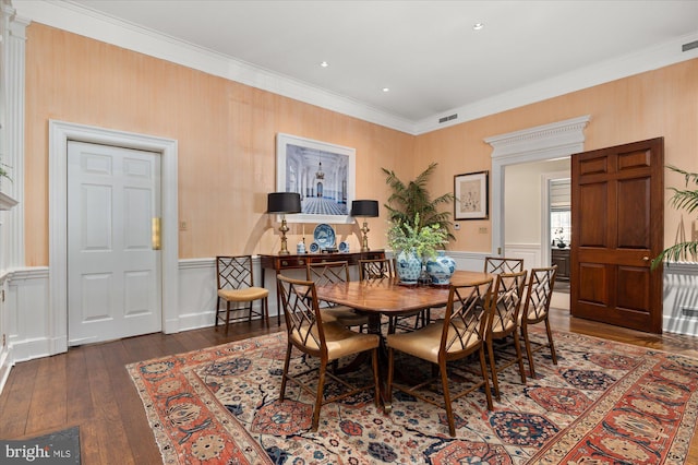 dining area featuring dark hardwood / wood-style flooring and crown molding