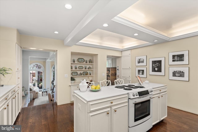 kitchen featuring electric stove, a center island, white cabinets, and dark hardwood / wood-style flooring