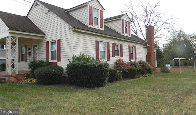 view of side of home featuring a yard