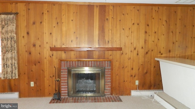 unfurnished living room featuring carpet flooring, a baseboard heating unit, and a brick fireplace