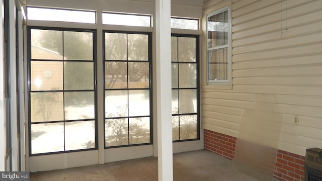 doorway featuring carpet floors