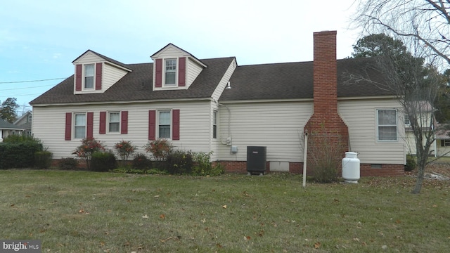 view of side of property with cooling unit and a lawn