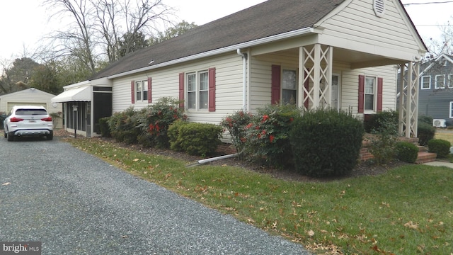 view of side of property featuring a yard and a carport