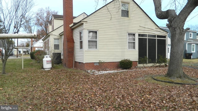 view of side of property featuring a sunroom