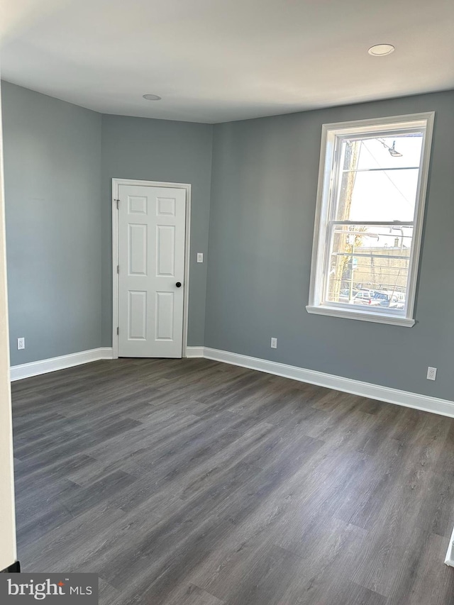 unfurnished room featuring dark hardwood / wood-style floors