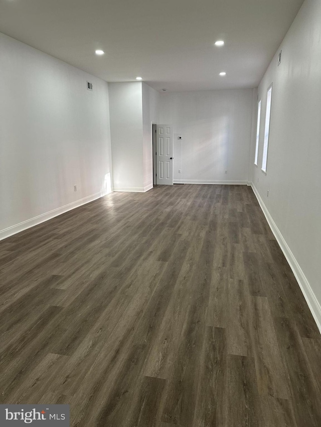 unfurnished room featuring dark wood-type flooring