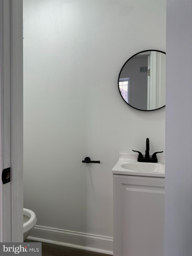 bathroom with vanity and toilet