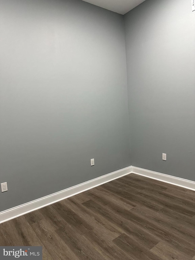 unfurnished room featuring dark hardwood / wood-style floors